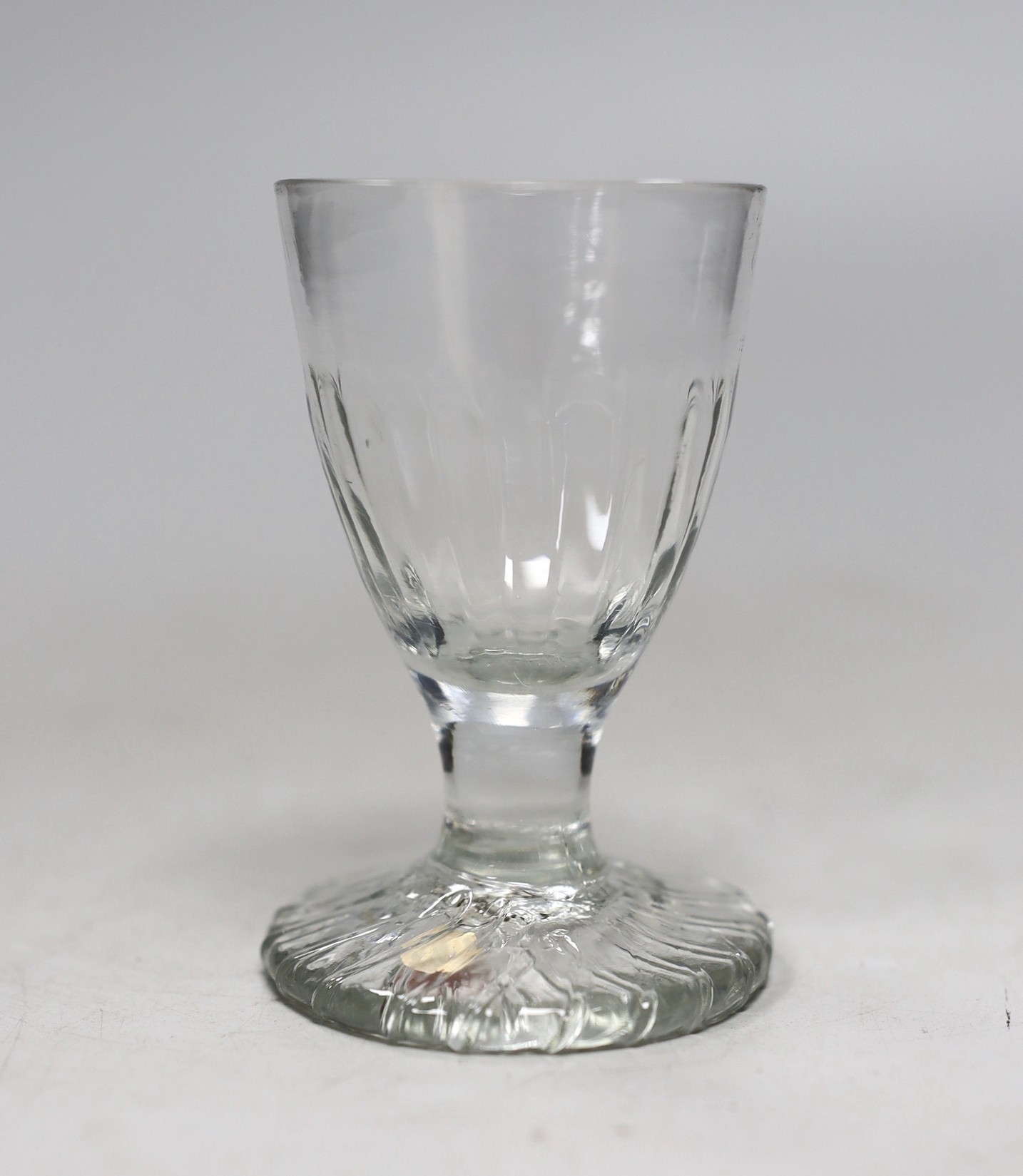 A Georgian moulded toasting glass. 9cm tall